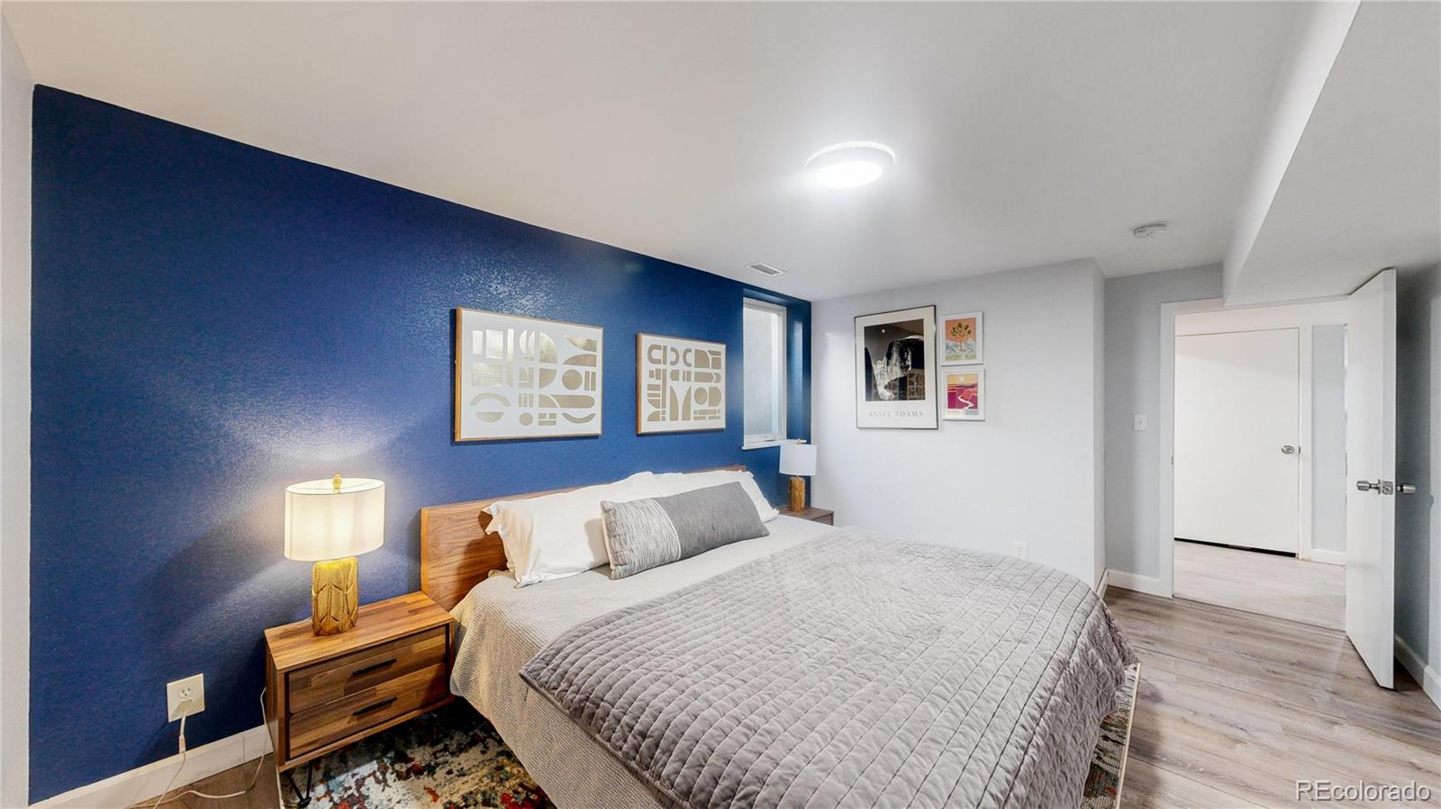 9420 Ridge Road Arvada, CO 80002 - Photo 14 of 31 a bedroom with a bed and a night stand