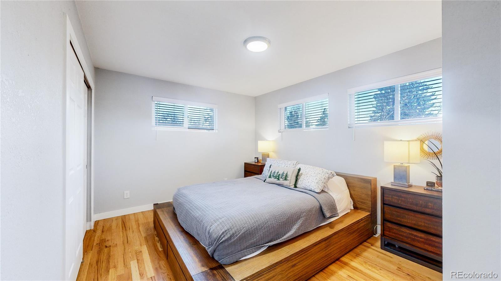 9420 Ridge Road Arvada, CO 80002 - Photo 20 of 31 a bedroom with a bed and wooden floor