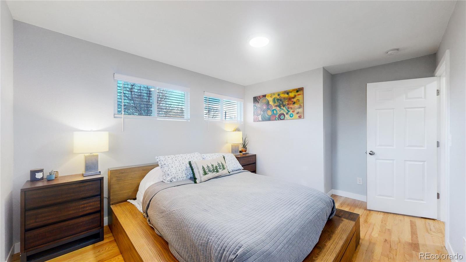 9420 Ridge Road Arvada, CO 80002 - Photo 21 of 31 a bedroom with a bed and wooden floor