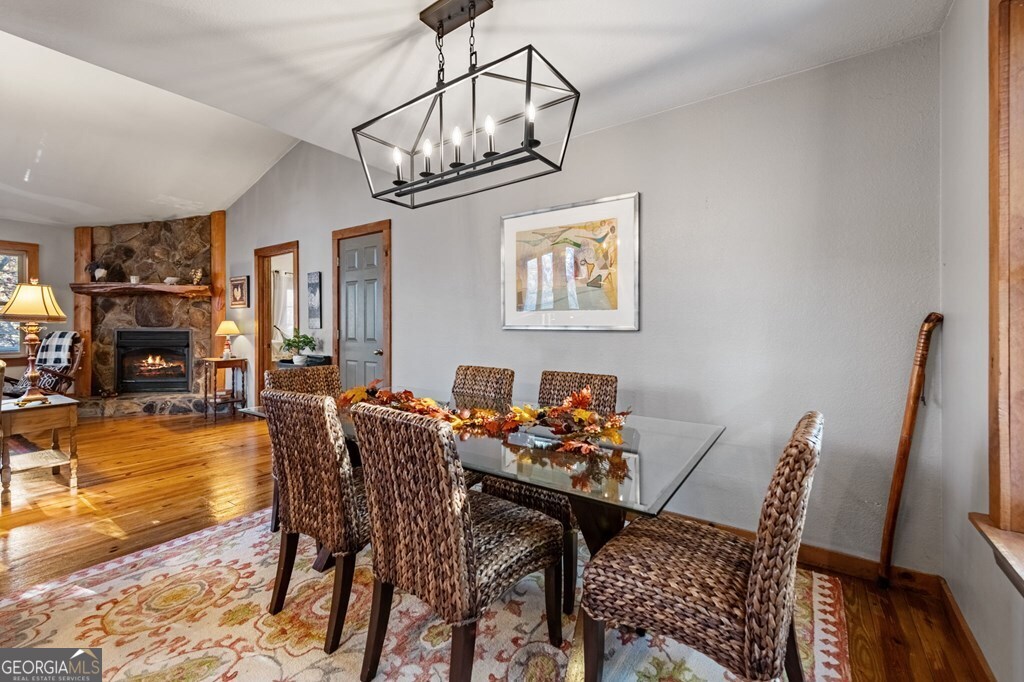 90 Hay Lane Morganton, GA 30560 - Photo 13 of 77 a dining room with furniture a chandelier and wooden floor