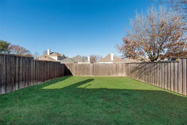 a view of yard with swimming pool and green space