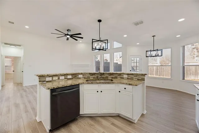 a kitchen with granite countertop a stove and a sink