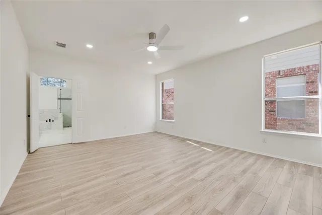 an empty room with windows and closet