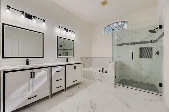 a bathroom with double sink and a mirror