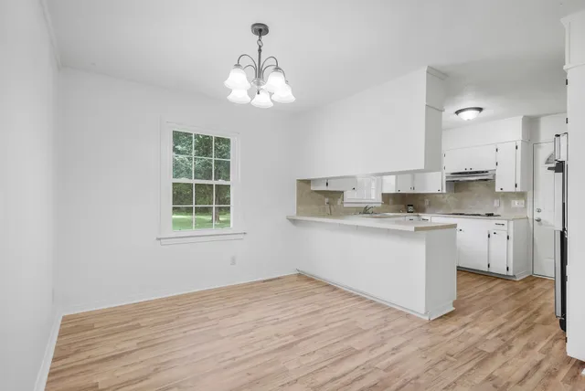 a kitchen with a refrigerator and stove top oven