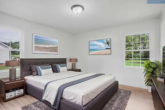 a bedroom with bed and a potted plant