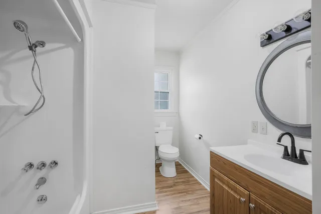 a bathroom with a sink a toilet and a mirror