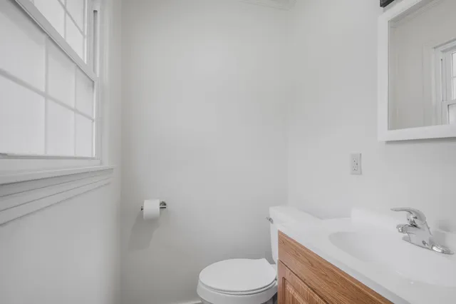 a bathroom with a sink toilet and vanity