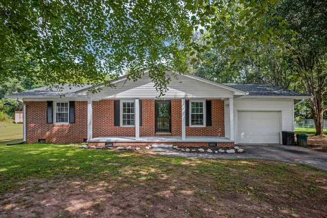 a front view of house with yard and green space