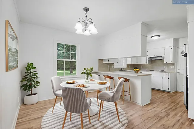 a dining room with wooden floor and a chandelier