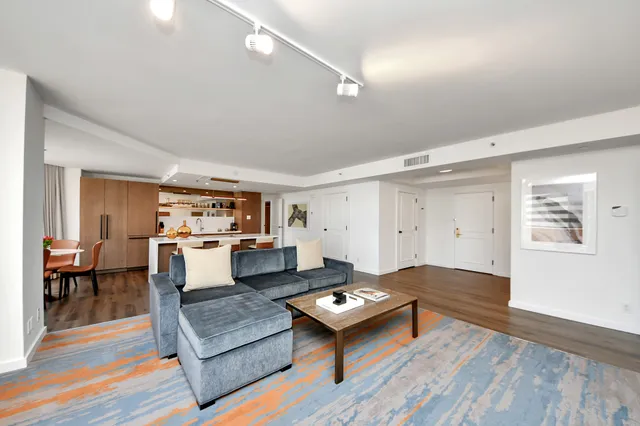 a living room with furniture and kitchen view