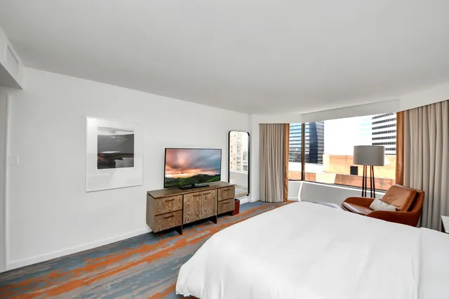 a bedroom with a bed and a large mirror