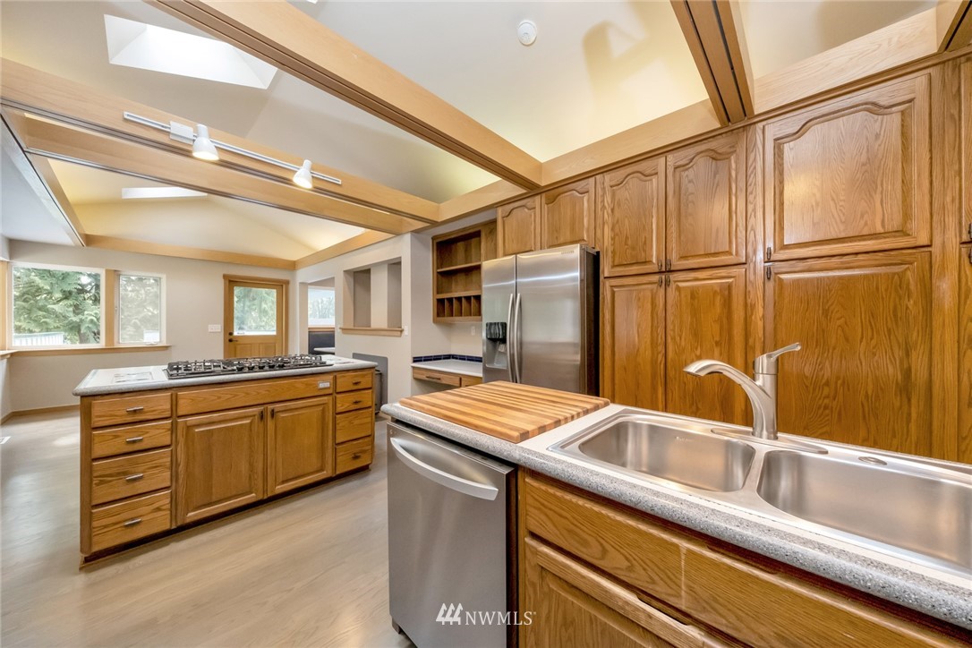 23304 35th Avenue Southeast Bothell, WA 98021 - Photo 12 of 34 a kitchen that has a sink and a refrigerator