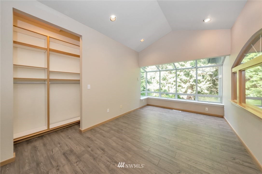 23304 35th Avenue Southeast Bothell, WA 98021 - Photo 13 of 34 an empty room with wooden floor and windows