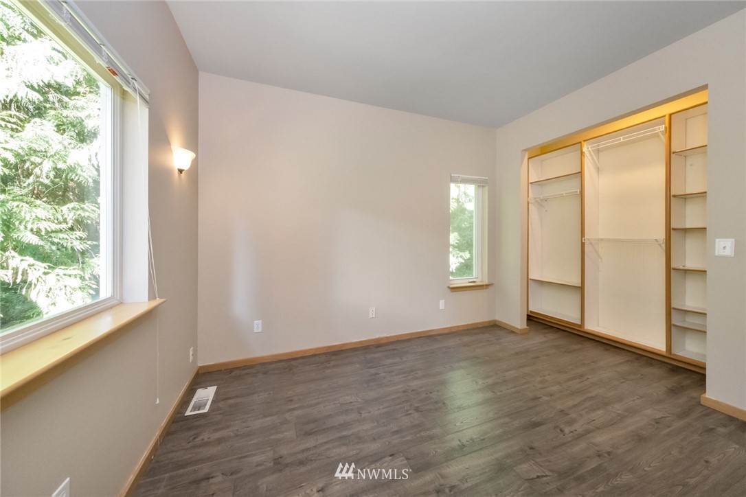 23304 35th Avenue Southeast Bothell, WA 98021 - Photo 14 of 34 an empty room with wooden floor and windows