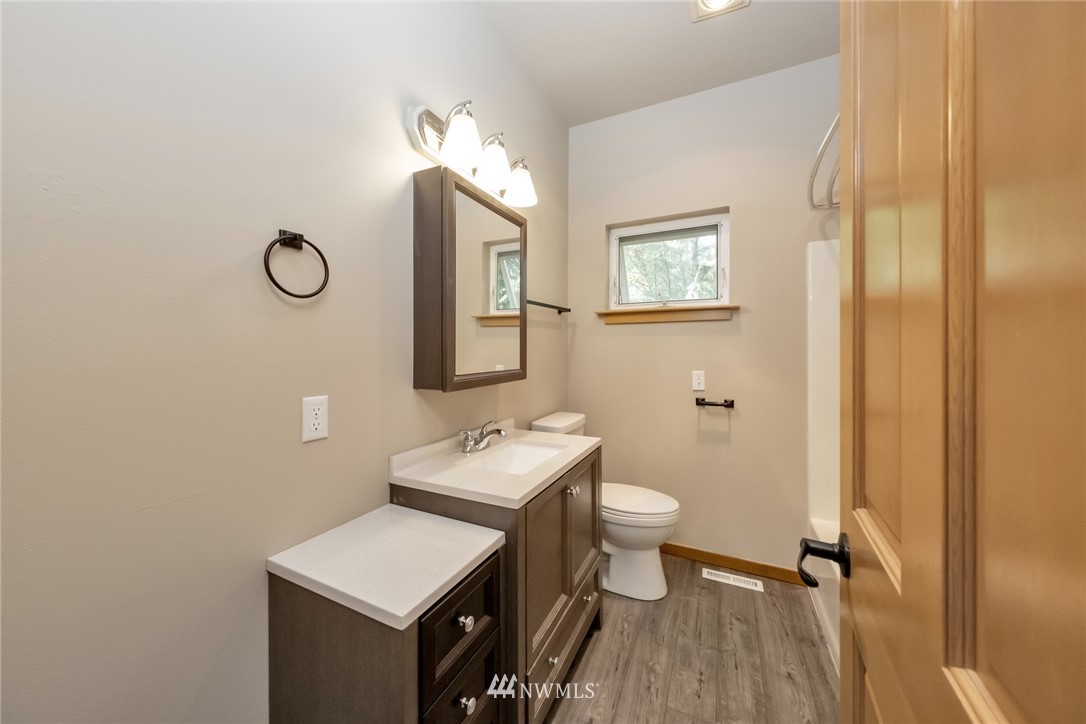 23304 35th Avenue Southeast Bothell, WA 98021 - Photo 15 of 34 a bathroom with a toilet a sink and mirror