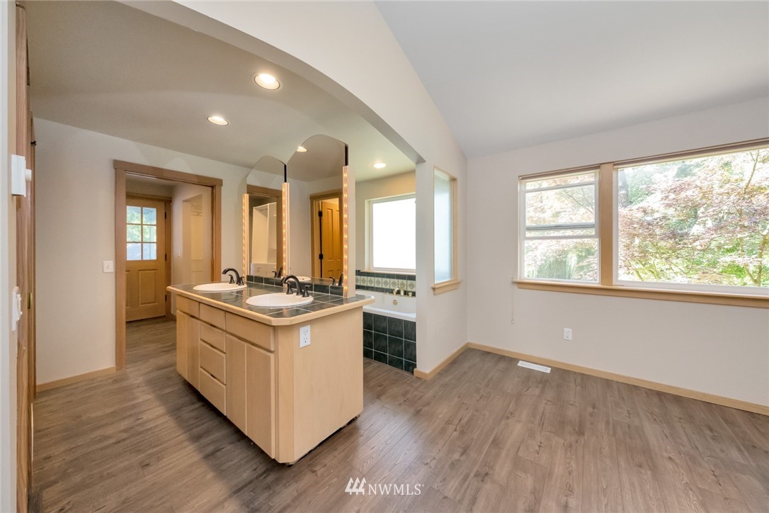 23304 35th Avenue Southeast Bothell, WA 98021 - Photo 17 of 34 a kitchen with stainless steel appliances granite countertop a stove and a large window