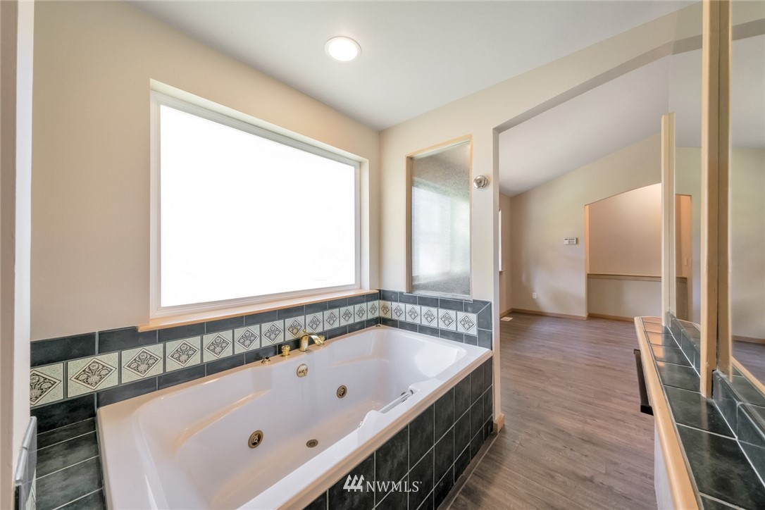 23304 35th Avenue Southeast Bothell, WA 98021 - Photo 19 of 34 a bathroom with a bathtub and a sink