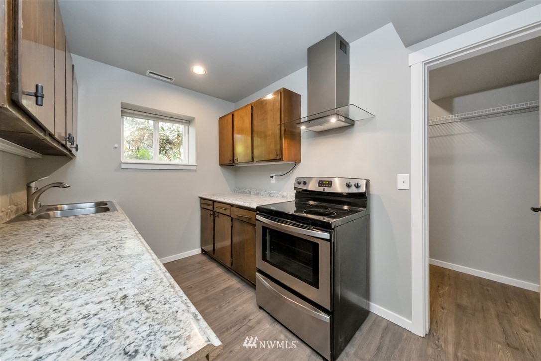 23304 35th Avenue Southeast Bothell, WA 98021 - Photo 26 of 34 a kitchen with stainless steel appliances granite countertop a stove and a sink