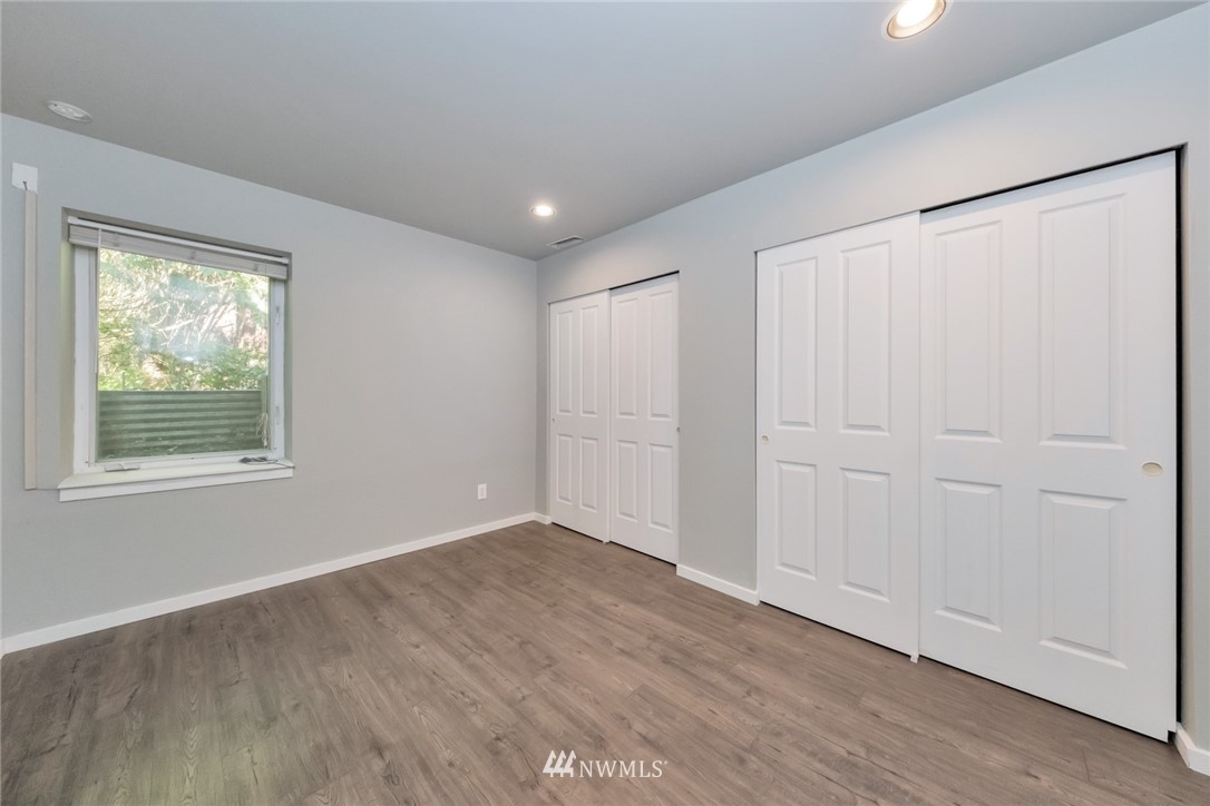 23304 35th Avenue Southeast Bothell, WA 98021 - Photo 27 of 34 a view of an empty room with wooden floor and a window