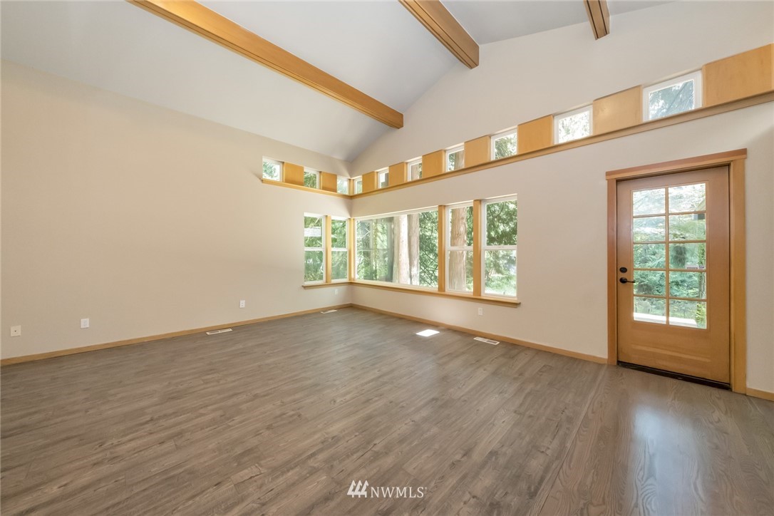 23304 35th Avenue Southeast Bothell, WA 98021 - Photo 7 of 34 a view of an empty room with a window and wooden floor