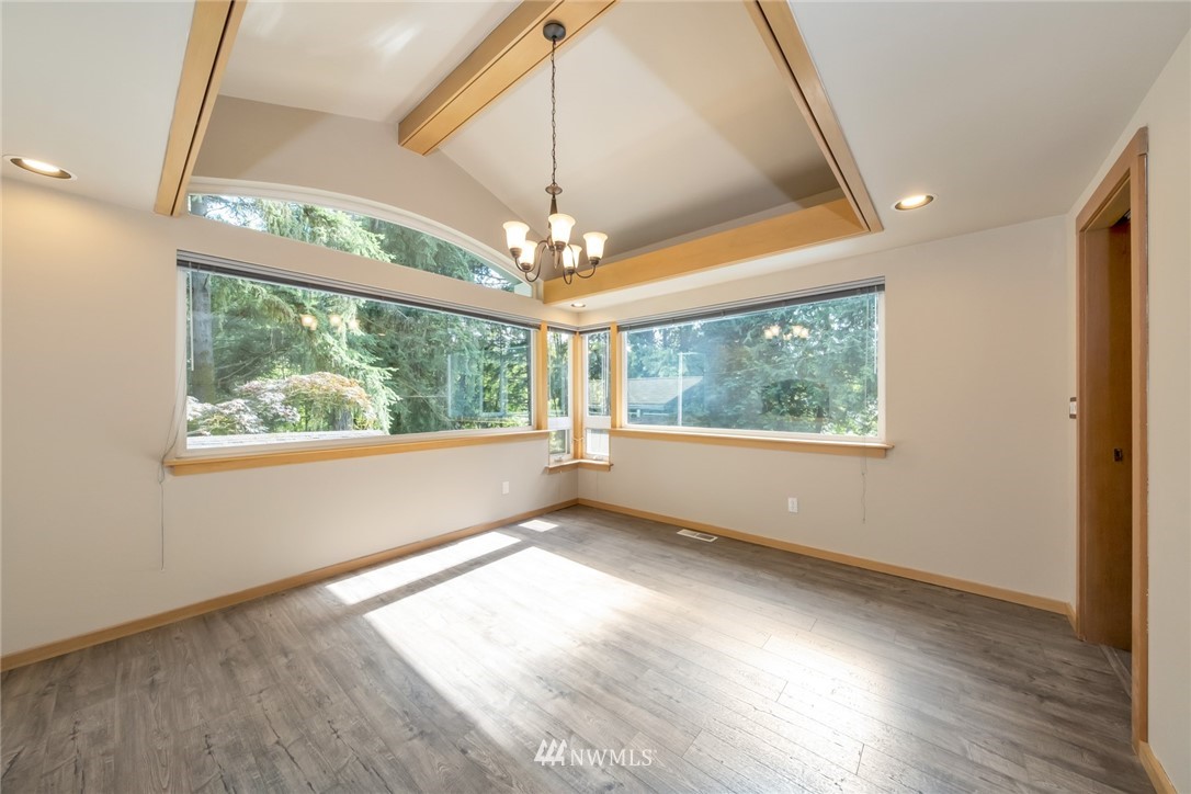 23304 35th Avenue Southeast Bothell, WA 98021 - Photo 8 of 34 an empty room with wooden floor fan and a floor to ceiling window