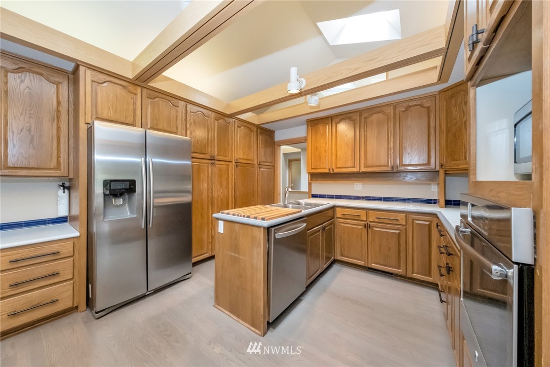 23304 35th Avenue Southeast Bothell, WA 98021 - Photo 10 of 34 a kitchen with stainless steel appliances granite countertop a refrigerator and a stove