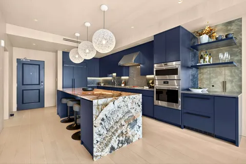 a large kitchen with stainless steel appliances granite countertop a stove and a sink