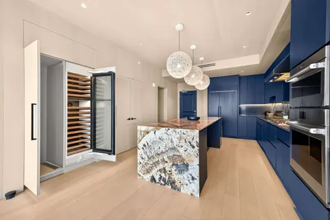 a view of kitchen island with cabinets and wooden floor