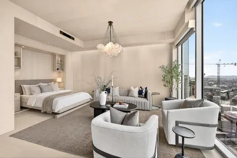 a spacious bedroom with bed and a couch