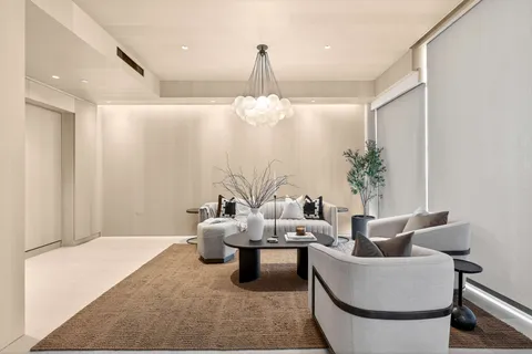 a living room with furniture and a chandelier