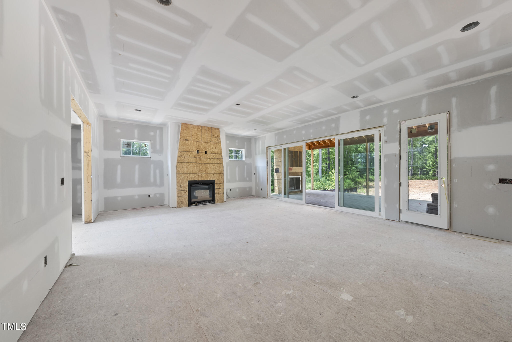1420 Starry Night Court Raleigh, NC 27613 - Photo 9 of 33 a view of an empty room with a fireplace and a window