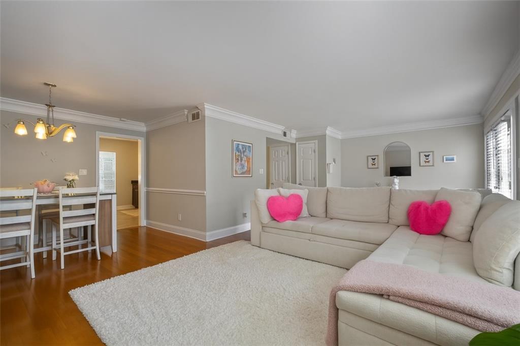 a living room with furniture and kitchen view