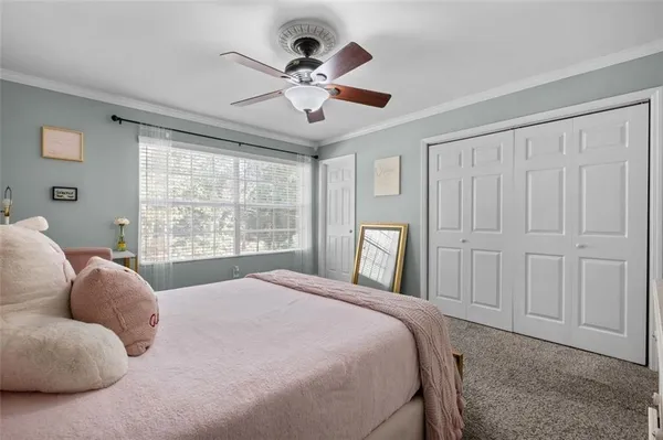 a bedroom with a large bed and a window