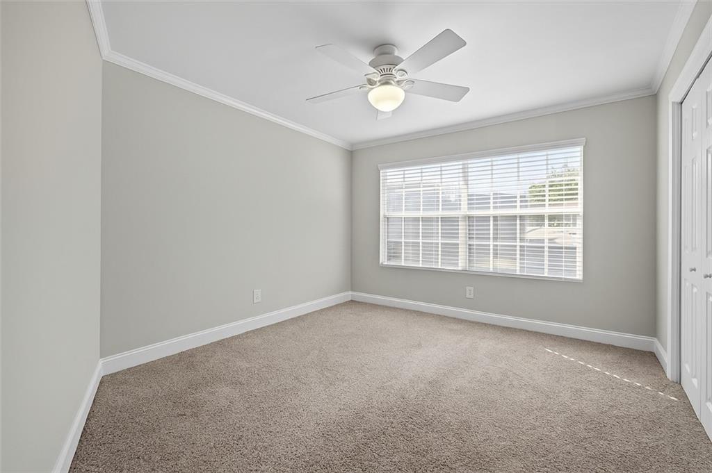 6980 Roswell Road, Unit A8 Atlanta, GA 30328 - Photo 16 of 26 an empty room with windows and fan
