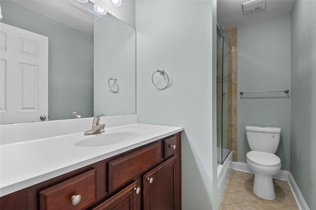 6980 Roswell Road, Unit A8 Atlanta, GA 30328 - Photo 19 of 26 a bathroom with a sink toilet and vanity