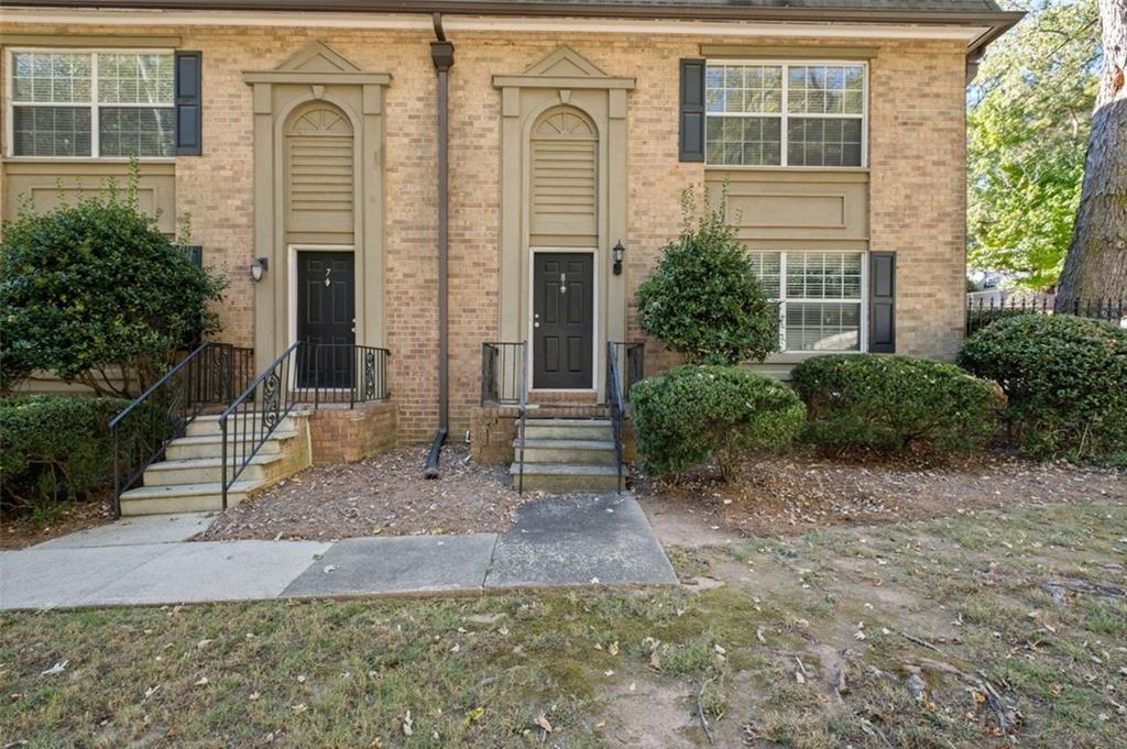 6980 Roswell Road, Unit A8 Atlanta, GA 30328 - Photo 22 of 26 a front view of a house with garden