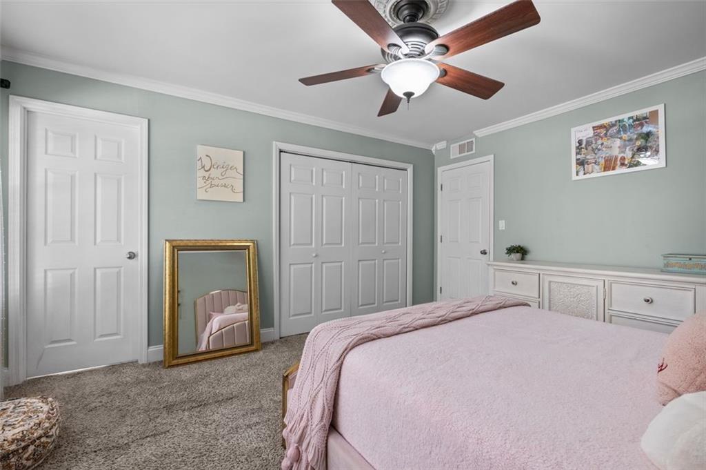6980 Roswell Road, Unit A8 Atlanta, GA 30328 - Photo 10 of 26 a bedroom with a bed and a chandelier