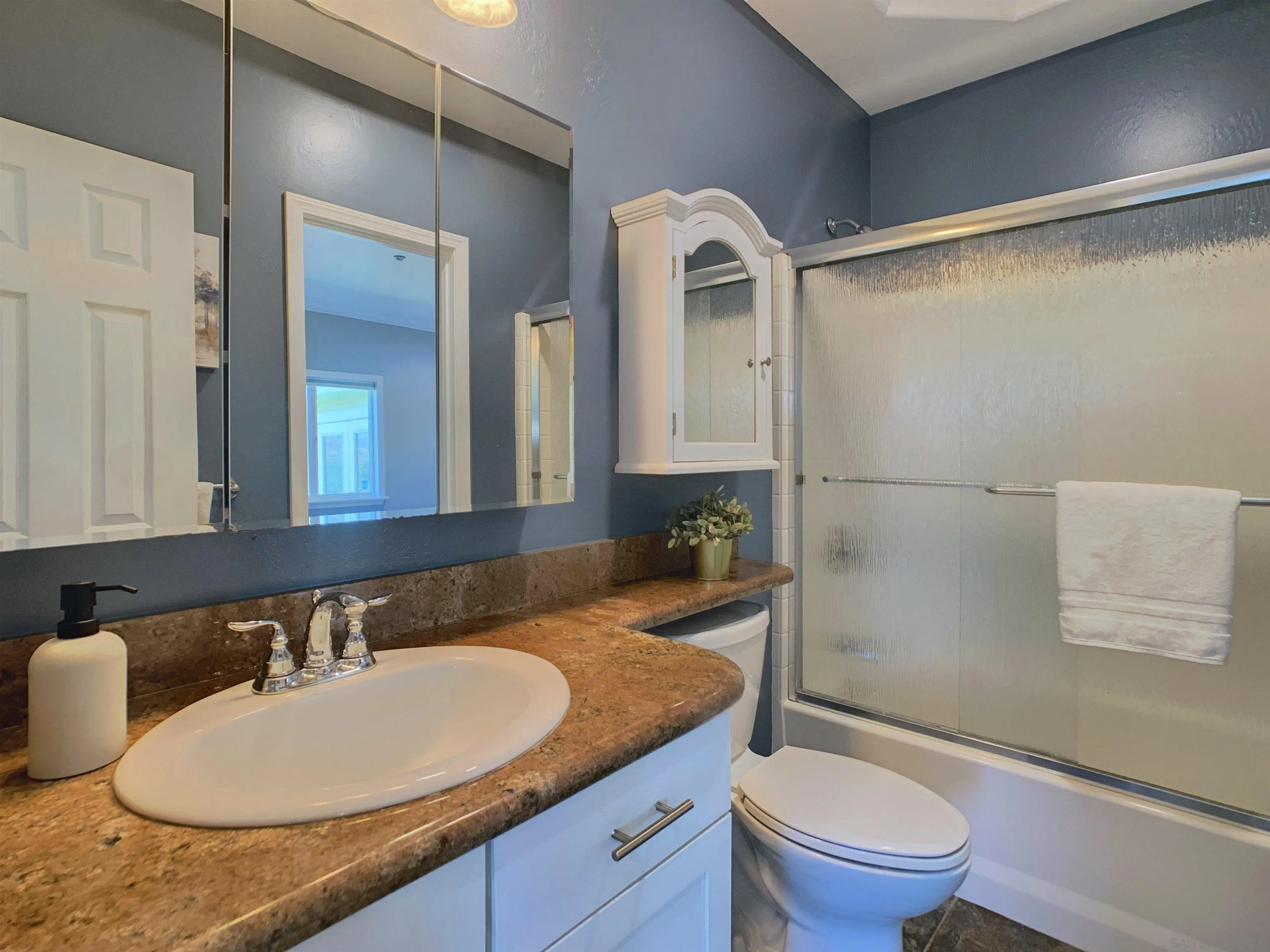 205 Highline Trail El Cajon, CA 92021 - Photo 29 of 45 a bathroom with a granite countertop sink mirror vanity and toilet