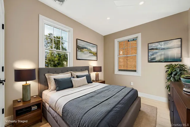 a bedroom with a bed and a potted plant
