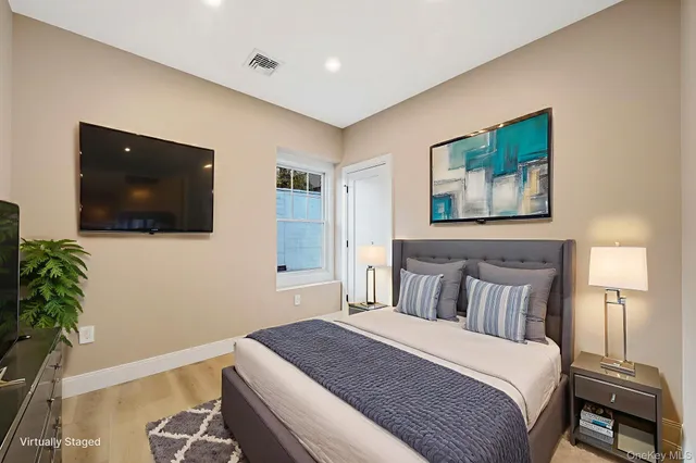 a bedroom with a bed and a flat screen tv