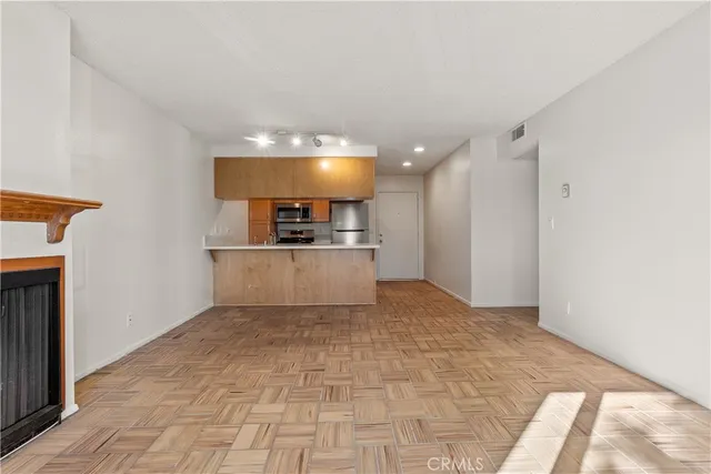 a view of a kitchen with a sink and a refrigerator