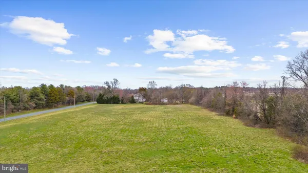 a view of a field with an ocean