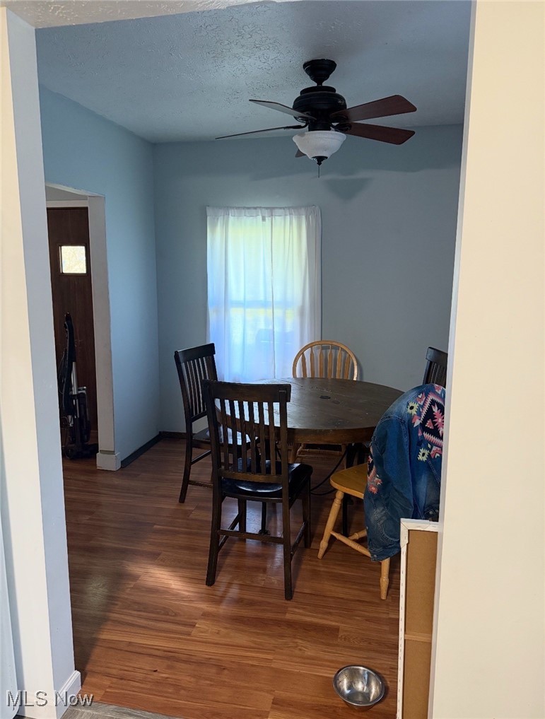 36354 Butternut Ridge Road North Ridgeville, OH 44039 - Photo 5 of 10 Dining room featuring a textured ceiling, baseboards, wood finished floors, and a ceiling fan