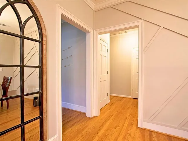 a spacious bedroom with a bed and a chandelier