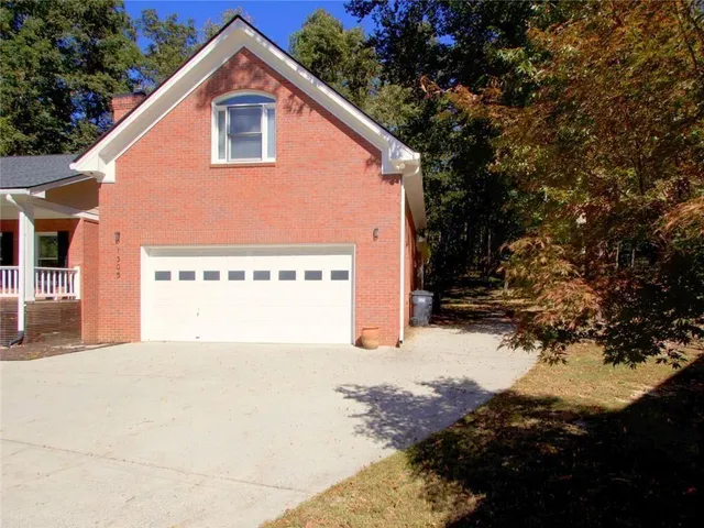 a view of a livingroom with a chandelier fan and windows