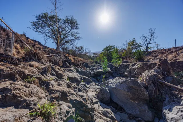 a view of an ocean beach and mountain