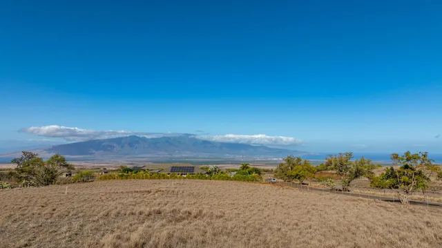 a view of an ocean beach and mountain