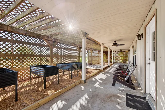 a kitchen with stainless steel appliances kitchen island granite countertop a refrigerator a stove and a wooden floors