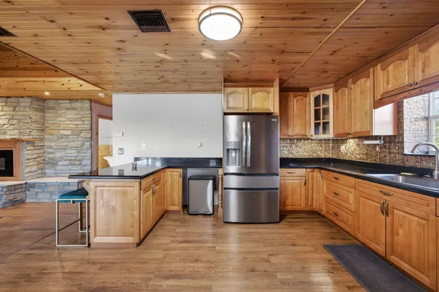 a living room with furniture a wooden floor and next to a window